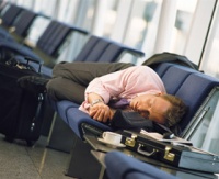 Man-sleeping-airport